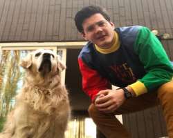 The star is accompanied by a cute dog in his home. 